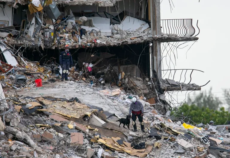 South Florida Urban Search and Rescue team look through rubble for survivors at the partially collapsed Champlain Towers South condo building in Surfside, Fla., Monday, June 28, 2021.