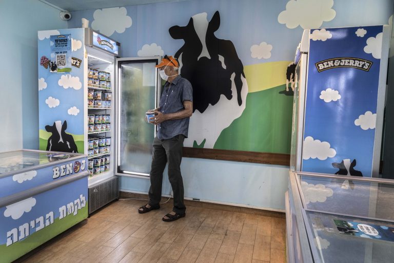 FILE - In this Tuesday, July 20, 2021 file photo, an Israeli shops at the Ben & Jerry's ice-cream factory in the Be'er Tuvia Industrial area, southern Israel. Unilever, the owner of Ben & Jerry's, sold itsÂ Ben & Jerry's business in IsraelÂ on June 28, 2022 to its distributor in the country. (AP Photo/Tsafrir Abayov, File)