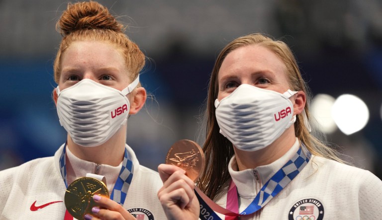 Gold medalist Lydia Jacoby, left, of the United States, stands with compatriot and bronze medalist Lilly King after the final of the women's 100-meter breaststroke at the 2020 Summer Olympics, Tuesday, July 27, 2021, in Tokyo, Japan.