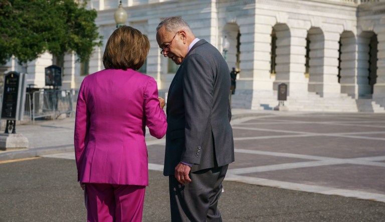 Speaker of the House Nancy Pelosi, D-Calif., left, and Senate Majority Leader Chuck Schumer, D-N.Y., speak privately before an event to address the urgent need to counter climate change in the US with transformational investments in clean jobs, at the Capitol in Washington, Wednesday, July 28, 2021.
