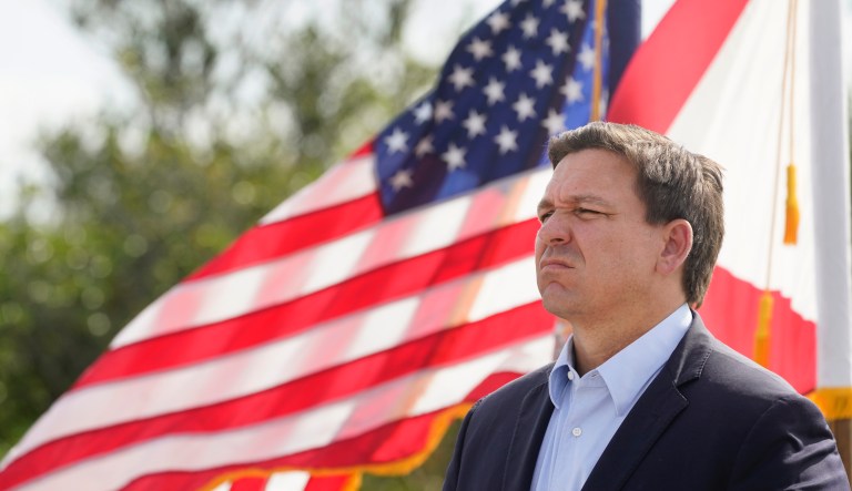 Florida Gov. Ron DeSantis listens during a news conference, Tuesday, Aug. 3, 2021, near the Shark Valley Visitor Center in Miami. DeSantis is doubling down as the state again broke its record for COVID-19 hospitalizations. The Republican governor insisted Tuesday that the spike will be short-lived.