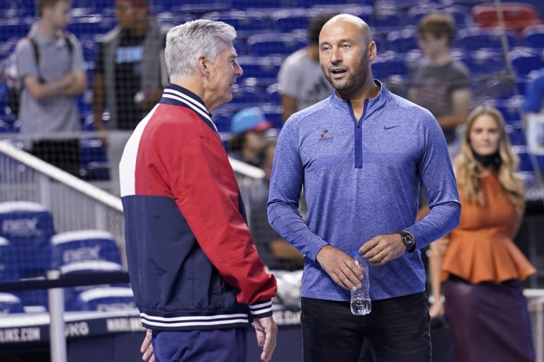 Philadelphia Phillies president of baseball operations Dave Dombrowski, left, talk with Miami Marlins CEO Derek Jeter, eight, before a baseball game, Saturday, Oct. 2, 2021, in Miami