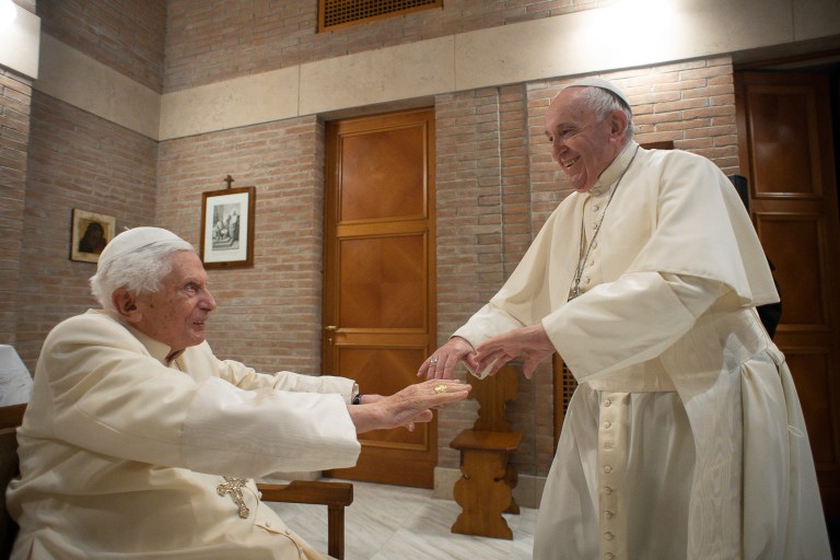 In this Nov. 28, 2020, file photo, Pope Francis holds hands with Pope Emeritus Benedict XVI as he pays him a visit at the Vatican. On Wednesday, Dec. 28, 2022, Francis asked for prayers for Benedict, saying he was 