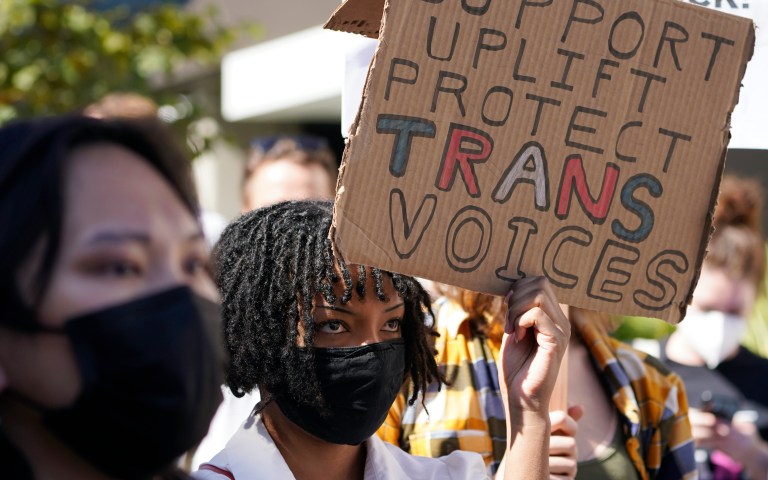 Critics and supporters of Dave Chappelle's Netflix special and its anti-transgender comments. (AP Photo/Damian Dovarganes)