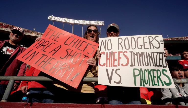 Fans holds up signs regarding Green Bay Packers quarterback Aaron Rodgers before the start of an NFL football game between the Kansas City Chiefs and the Green Bay Packers Sunday, Nov. 7, 2021, in Kansas City, Mo.