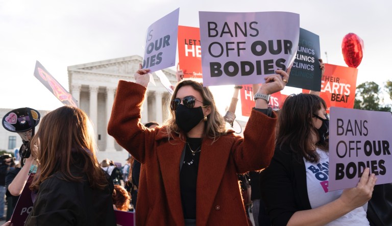Emily Halvorson, center, of Washington, with Planned Parenthood, joins groups of abortion-rights and anti-abortion activists as they rally outside the Supreme Court, on, Nov. 1, 2021, as arguments are set to begin about abortion by the court, on Capitol Hill in Washington. 