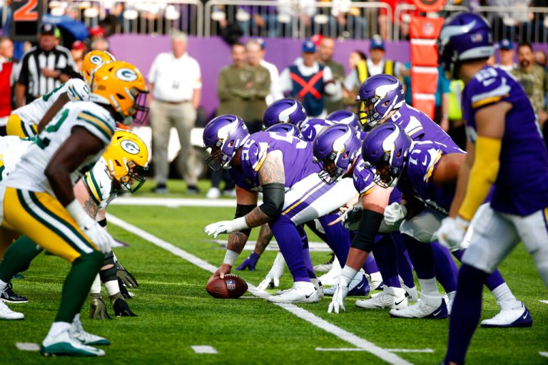 Players get set on the line of scrimmage during the first half of an NFL football game between the Minnesota Vikings and the Green Bay Packers, Sunday, Nov. 21, 2021, in Minneapolis.