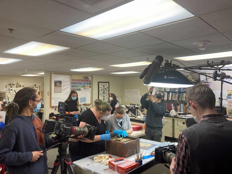 The lead conservator for the Virginia Department of Historic Resources, Kate Ridgway, in black, works with other conservators on a box believed to be a time capsule left in the pedestal at the former site of a statue of Confederate Gen. Robert E. Lee in Richmond, Virginia, on Tuesday, Dec. 28, 2021. 