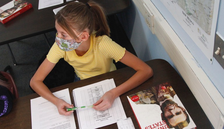 Charlotte Herman, age 13, listens as history teacher Wendy Leighton discusses the Salem witch trials with her students at Monte del Sol Charter School, Friday, Dec. 3, 2021, in Santa Fe, NM.