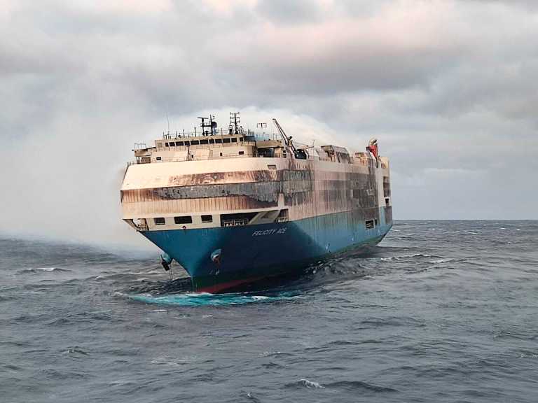 In this undated photo provided by the Portuguese Navy, smoke billows from the burning Felicity Ace car transport ship as seen from the Portuguese Navy NPR Setubal ship southeast of the mid-Atlantic Portuguese Azores Islands.
