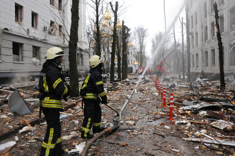 Firefighters extinguish a building of Ukrainian Security Service (SBU) after a rocket attack in Kharkiv, Ukraine's second-largest city, Ukraine, Wednesday, March 2, 2022. (AP Photo/Andrew Marienko)