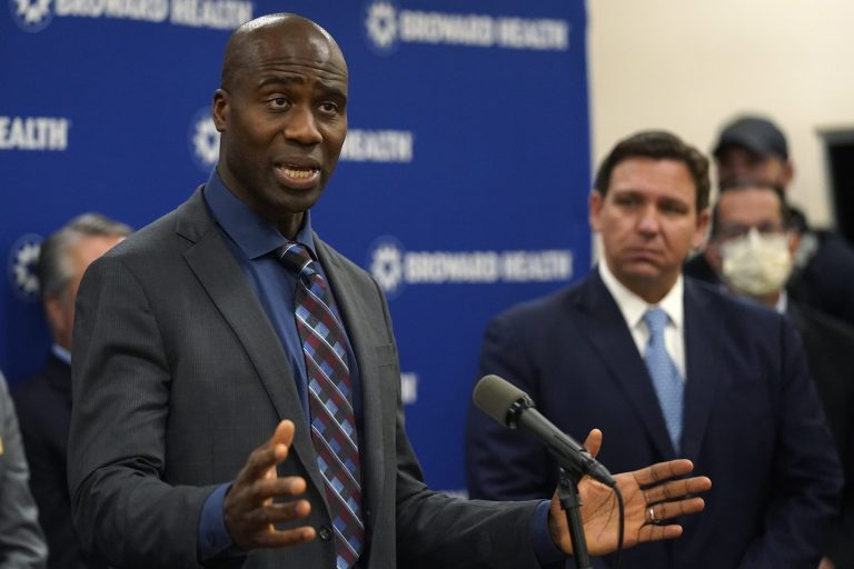  Florida Surgeon Gen. Dr. Joseph A. Ladapo, left, speaks at a news conference with Florida Gov. Ron DeSantis, right, Monday, Jan. 3, 2022, at Broward Health Medical Center in Fort Lauderdale, Fla.