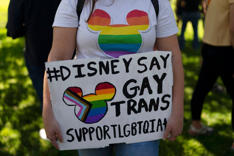 Disney employee Tiffany Cooper holds a sign to protest the company's stance on LGBTQ issues in Glendale, Calif., on March 22.