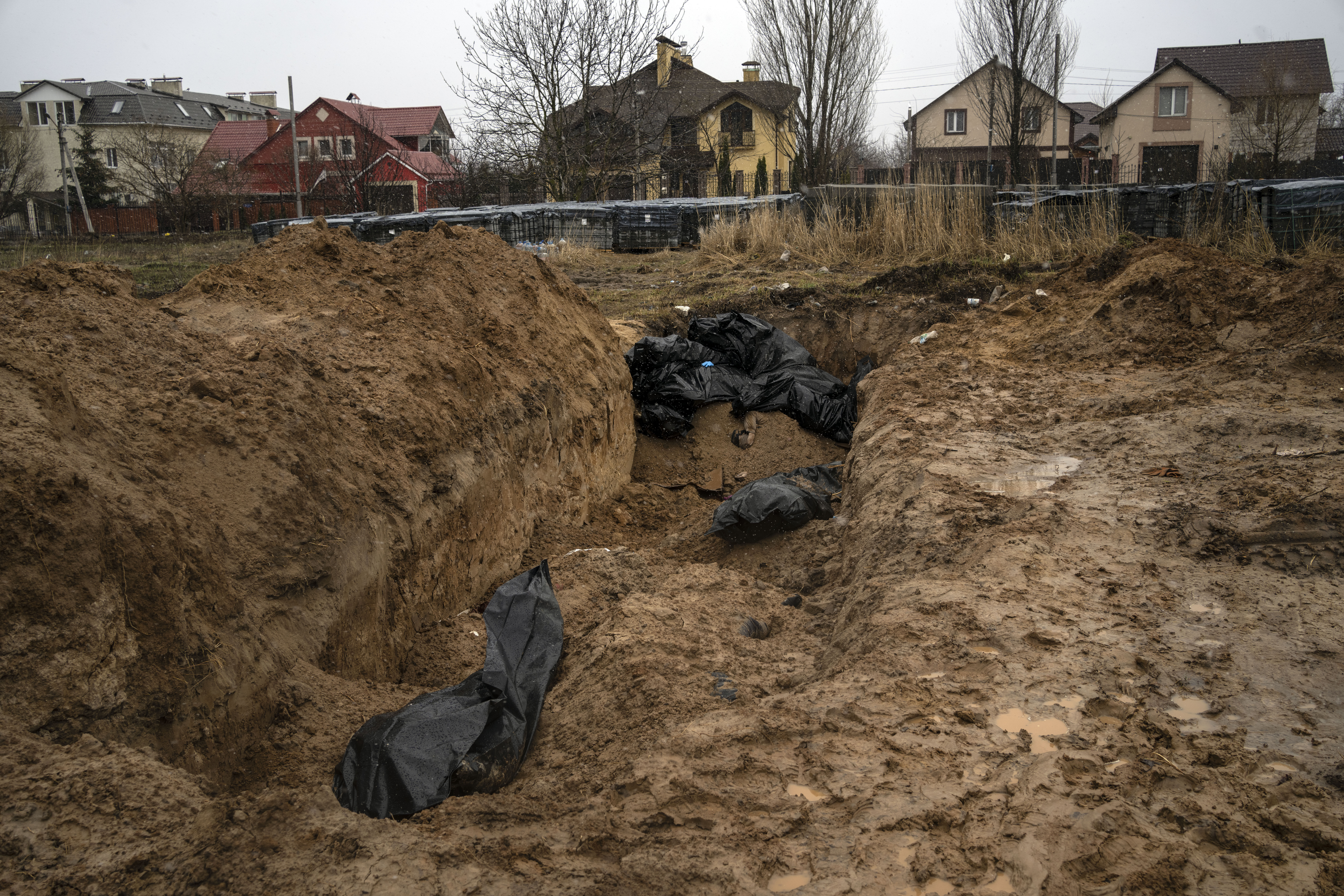 Bodies lie in a mass grave in Bucha, on the outskirts of Kyiv, Ukraine, on Sunday. Ukrainian troops are finding brutalized bodies and widespread destruction in the suburbs of Kyiv, sparking new calls for a war crimes investigation and sanctions against Russia.