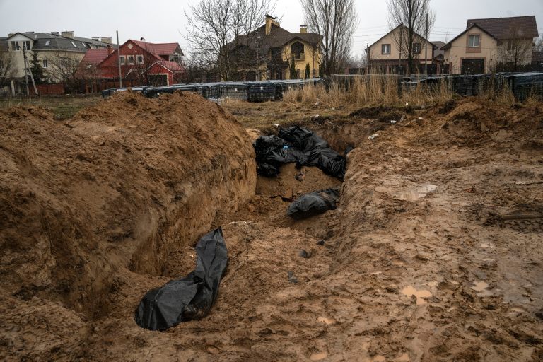 Bodies lie in a mass grave in Bucha, on the outskirts of Kyiv, Ukraine, on Sunday. Ukrainian troops are finding brutalized bodies and widespread destruction in the suburbs of Kyiv, sparking new calls for a war crimes investigation and sanctions against Russia. 
