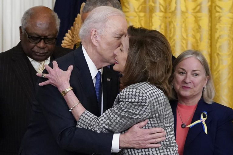 President Joe Biden kisses House Speaker Nancy Pelosi of Calif., during an Affordable Care Act event in the East Room of the White House in Washington, Tuesday, April 5, 2022.