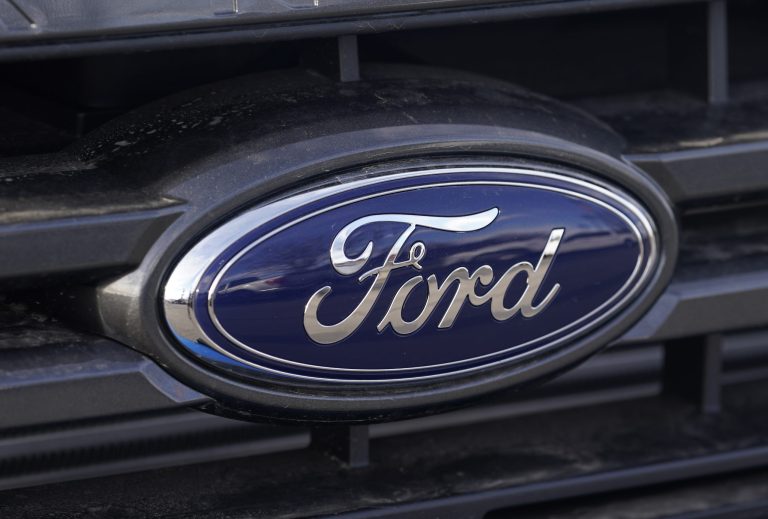 FILE - In this Sunday, April 25, 2021, photograph, the blue oval logo of Ford Motor Company is shown at a dealership in east Denver. 