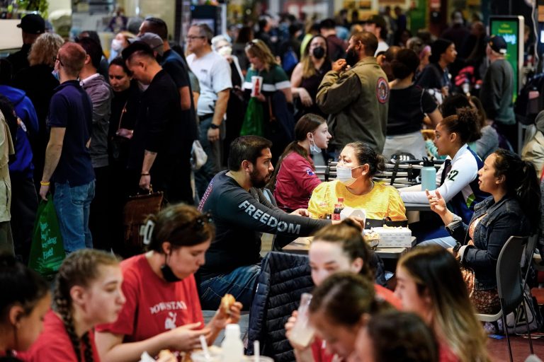 Customers, some wearing face masks to protect against the spread of the coronavirus, dine at the Reading Terminal Market in Philadelphia on Friday.