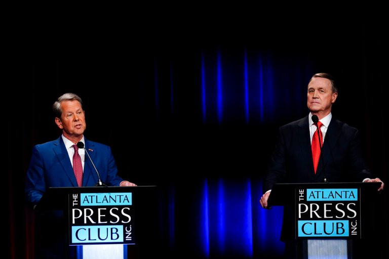 Georgia Gov. Brian Kemp, left, speaks during a gubernatorial republican primary debate toward Former Sen. David Perdue, right, on Sunday, May 1, 2022, in Atlanta.