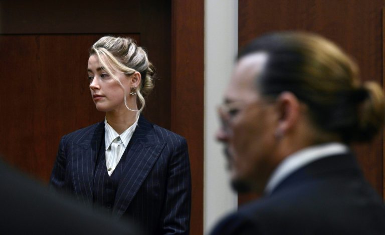 Actors Amber Heard and Johnny Depp, watch the jury arrive in the courtroom at the Fairfax County Circuit Courthouse in Fairfax, Va., Tuesday, May 17, 2022. Depp sued his ex-wife Amber Heard for libel in Fairfax County Circuit Court after she wrote an op-ed piece in The Washington Post in 2018 referring to herself as a 