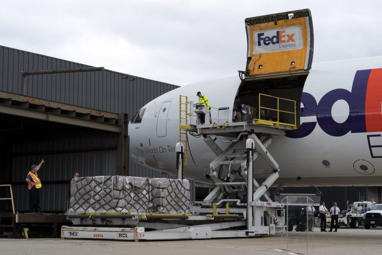 Workers unload a Fedex Express cargo plane at Washington Dulles International Airport, in Chantilly, Virginia., on Wednesday, May 25, 2022. 