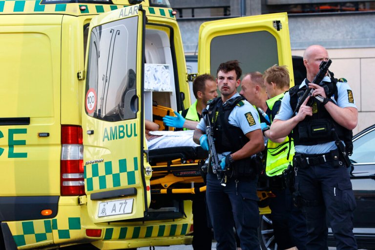 An ambulance and armed police outside the Field's shopping center, in Orestad, Copenhagen, Denmark, Sunday, July 3, 2022, after reports of shots fired.