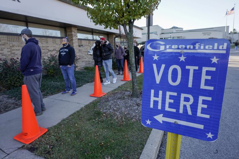 People line up to vote outside the Greenfield Community Center on Election Day in Greenfield, Wis. 