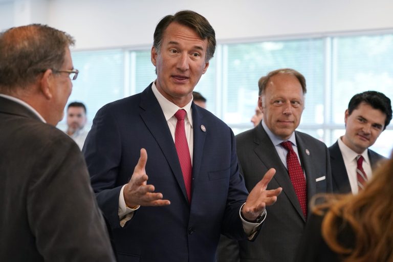 Virginia Gov. Glenn Youngkin gestures as he talks with employees during opening ceremonies for the new offices of Empower AI Wednesday, July 20, 2022, in Richmond, Virginia.