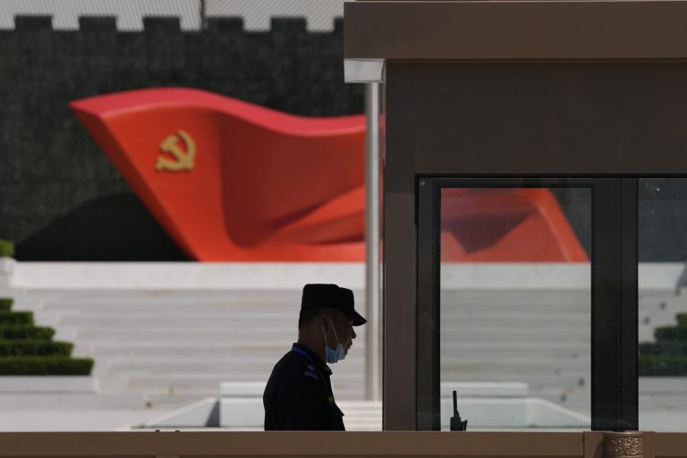 FILE - A security guard stands near a sculpture of the Chinese Communist Party flag at the Museum of the Communist Party of China on May 26, 2022, in Beijing. China said it was conducting military exercises Saturday, July 30, off its coast opposite Taiwan after warning Speaker Nancy Pelosi of the U.S. House of Representatives to scrap possible plans to visit the island democracy, which Beijing claims as part of its territory.