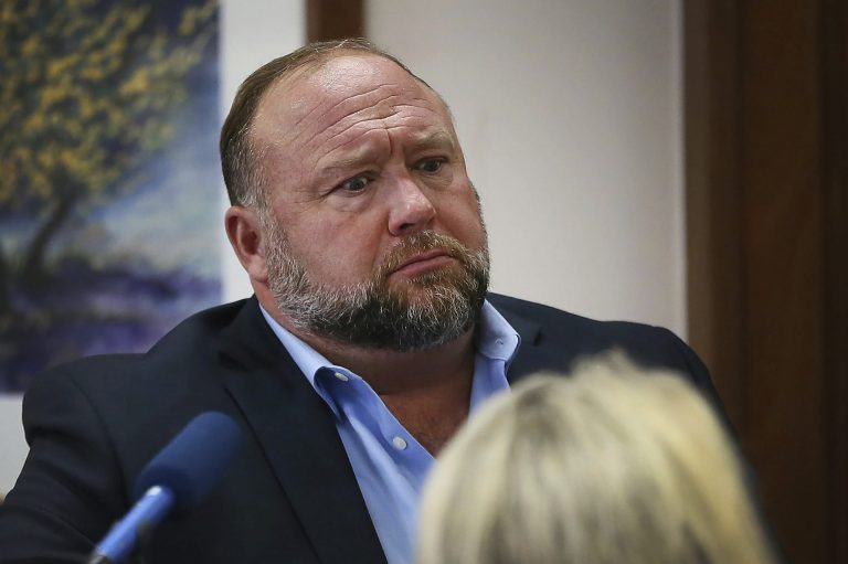 Conspiracy theorist Alex Jones attempts to answer questions about his emails during trial at the Travis County Courthouse in Austin, Texas, on Wednesday.