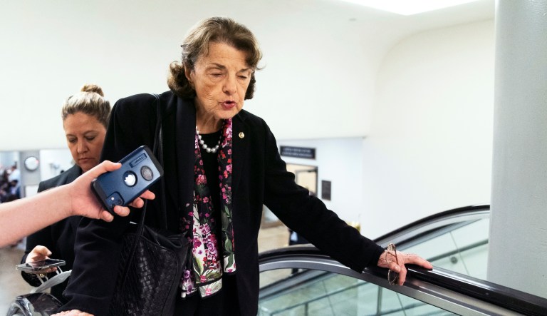 Sen. Dianne Feinstein, D-Calif., speaks to reporters as she takes the escalator on Capitol Hill in Washington, Thursday, Aug. 4, 2022.