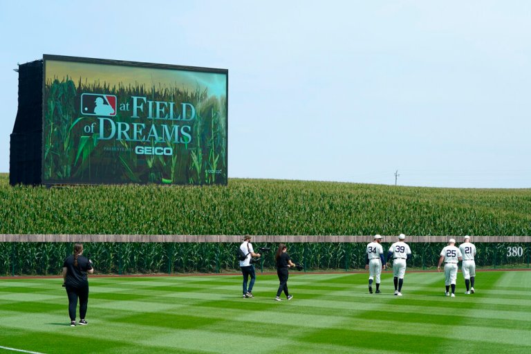 Chicago White Sox players walk on the field before a baseball game against the New York Yankees in Dyersville, Iowa.