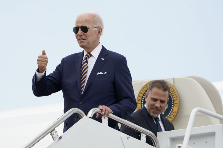 President Joe Biden gives a thumbs-up as he boards Air Force One with his son Hunter Biden (right) at Andrews Air Force Base in Maryland on Aug. 10, 2022.
