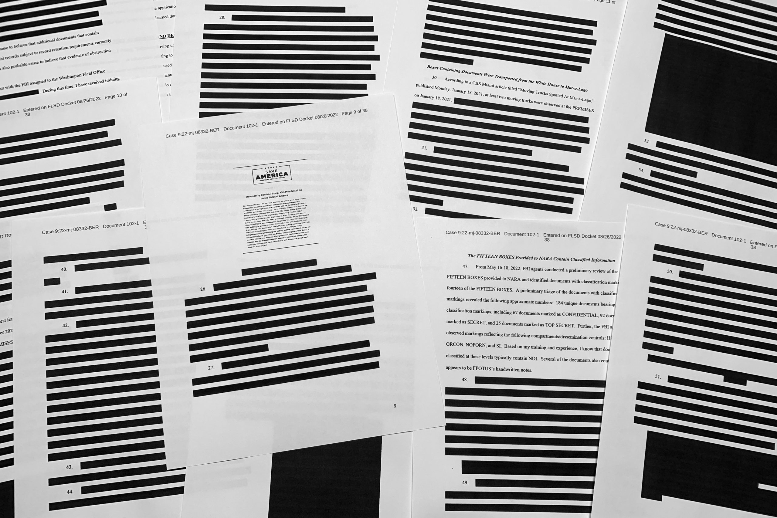 Pages from the affidavit by the FBI in support of obtaining a search warrant for former President Donald Trump's Mar-a-Lago estate are photographed Friday, Aug. 26, 2022. U.S. Magistrate Judge Bruce Reinhart ordered the Justice Department to make public a redacted version of the affidavit it relied on when federal agents searched Trump's estate to look for classified documents. 