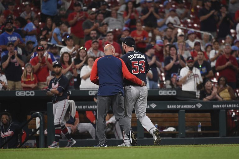 Atlanta Braves relief pitcher Jackson Stephens (53) is helped off the field by training staff after being hit by a line-drive by St. Louis Cardinals' Brendan Donovan (33) in the ninth inning of a baseball game against the Atlanta Braves on Friday, Aug. 26, 2022, in St. Louis.