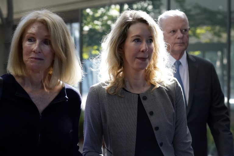 Former Theranos CEO Elizabeth Holmes, center, her mother, Noel Holmes, left, and father, Christian Holmes IV, arrive at federal court in San Jose, Calif., Thursday, Sept. 1, 2022.