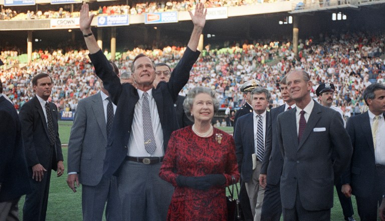 President George H.W. Bush escorts Queen Elizabeth II and Prince Philip on the field at Memorial Stadium in Baltimore.