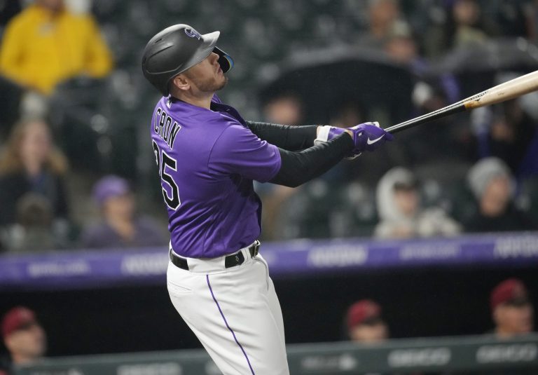Colorado Rockies' C.J. Cron flies out against Arizona Diamondbacks relief pitcher Caleb Smith in the eighth inning of a baseball game Friday, Sept. 9, 2022, in Denver.