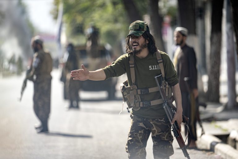 Taliban fighters stand guard at an explosion site, near a mosque, in Kabul, Afghanistan, Friday, Sept. 23, 2022.
