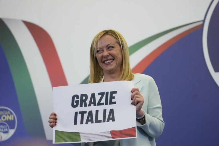Far-right party Brothers of Italy's leader Giorgia Meloni shows a placard reading in Italian 