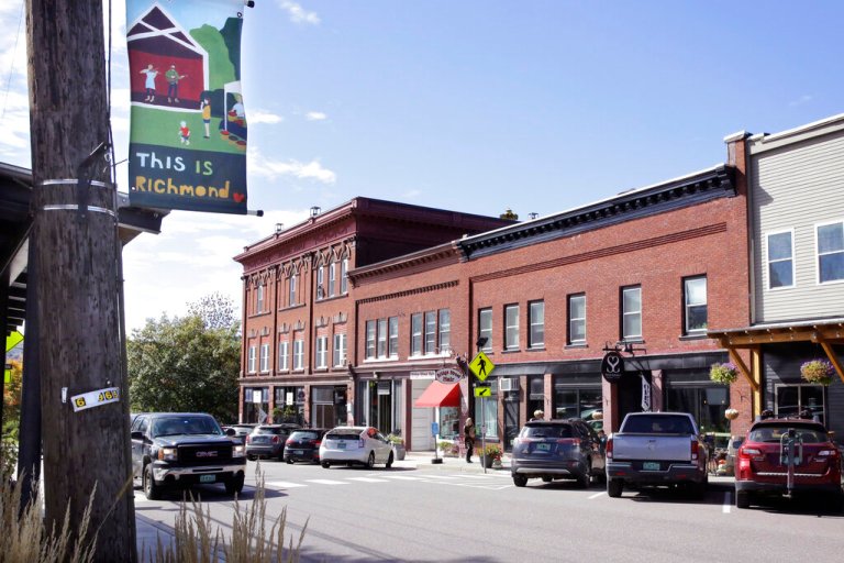 A pick-up truck rolls through downtown, Wednesday Oct. 5, 2022, in Richmond, Vt. A town employee in Richmond is under fire for lowering the fluoride level in the drinking water below the state's recommended level for more than three years. 