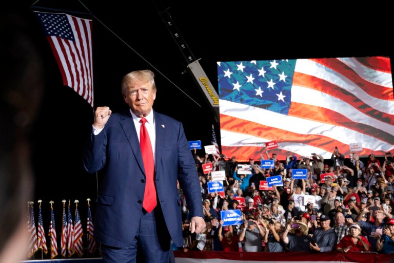 Former President Donald Trump makes his entrance at a rally at the Minden Tahoe Airport in Minden, Nev., Saturday, Oct. 8, 2022. 