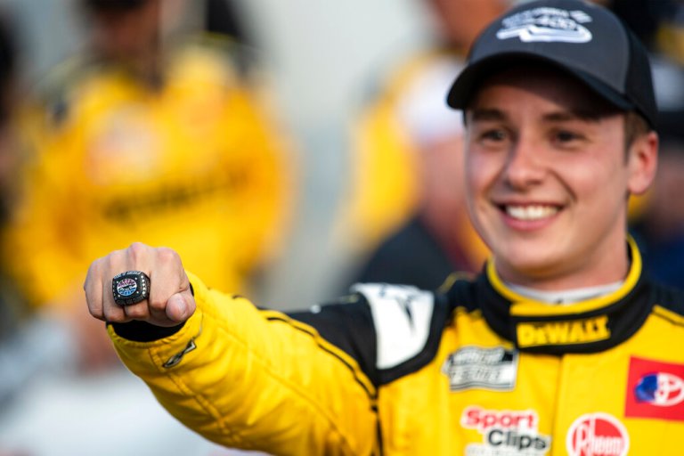 Christopher Bell holds out a ring he received for winning a NASCAR Cup Series auto race at Charlotte Motor Speedway, Sunday, Oct. 9, in Concord, North Carolina.