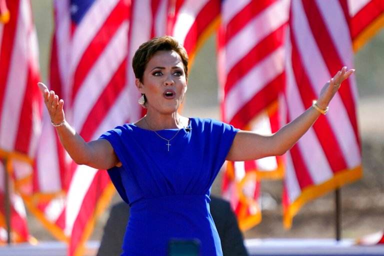 Arizona Republican gubernatorial candidate Kari Lake arrives to a rally with former President Donald Trump on Oct. 9, 2022, in Mesa, Ariz. The Republicans running for Arizona's three top statewide offices have said they would not have signed off on the presidential results if they had held office in 2020 and have signaled that they want to overhaul the battleground state's elections.