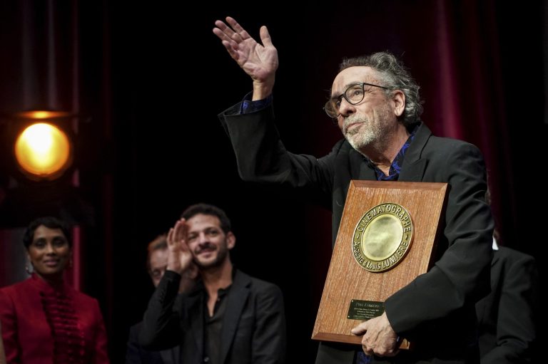 Film director Tim Burton holds his plaque during the Lumiere Award ceremony of the 14th Lumiere Festival in Lyon, France. 