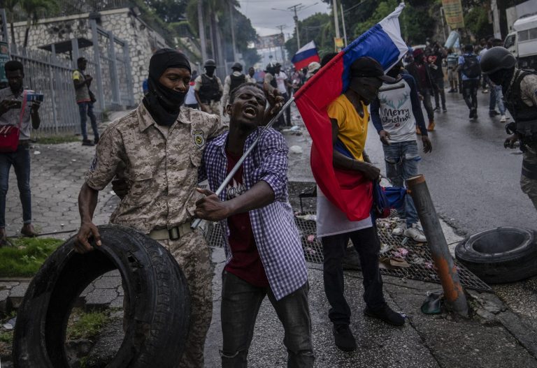 Police move demonstrators from in front of the Canadian embassy during a protest to reject an international military force requested by the government in Port-au-Prince, Haiti, Monday, Oct. 24, 2022.