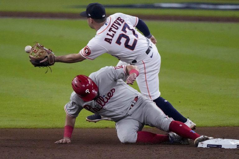 Philadelphia Phillies' Kyle Schwarber is safe after stealing second past Houston Astros second baseman Jose Altuve during the seventh inning in Game 1 of baseball's World Series between the Houston Astros and the Philadelphia Phillies on Friday, Oct. 28, 2022, in Houston.