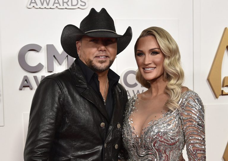 Jason Aldean (left) and his wife, Brittany, arrive at the 56th Annual CMA Awards on Wednesday, Nov. 9, 2022, at the Bridgestone Arena in Nashville, Tennessee. 