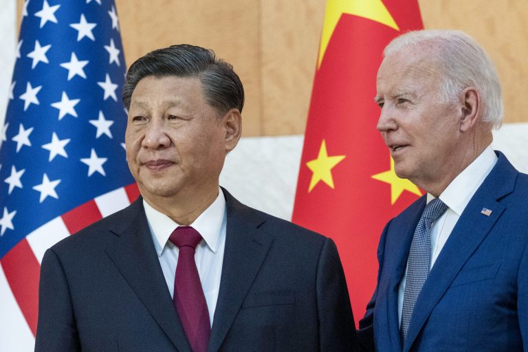 President Joe Biden, right, stands with Chinese President Xi Jinping before a meeting on the sidelines of the G20 summit meeting, Monday, Nov. 14, 2022, in Bali, Indonesia. Biden says Chinese counterpart Xi has agreed to resume crucial talks on climate between the two countries. The Chinese and U.S. leaders met Monday on the sidelines of the Group of 20 summit in Bali.