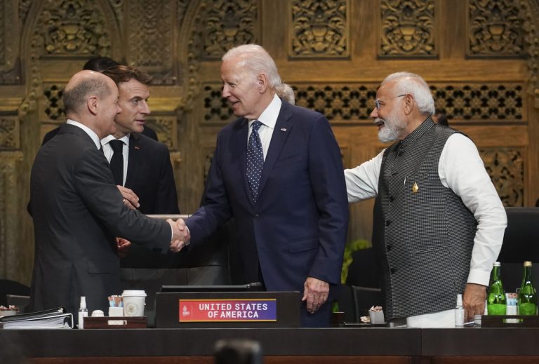 U.S. President Joe Biden, France's President Emmanuel Macron, Germany's Chancellor Olaf Scholz, and India's Prime Minister Narendra Modi greet each other during the first working session of the G-20 leaders summit in Nusa Dua, Indonesia, Tuesday, Nov. 15, 2022. 